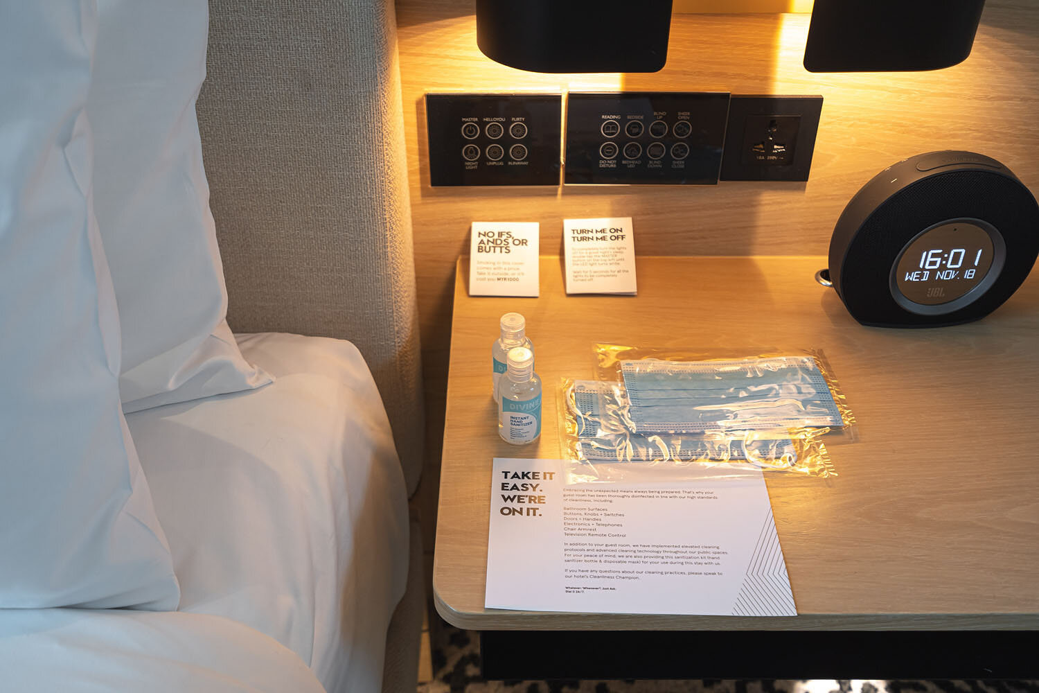  Masks, hand sanitisers and lighting controls near the bed 