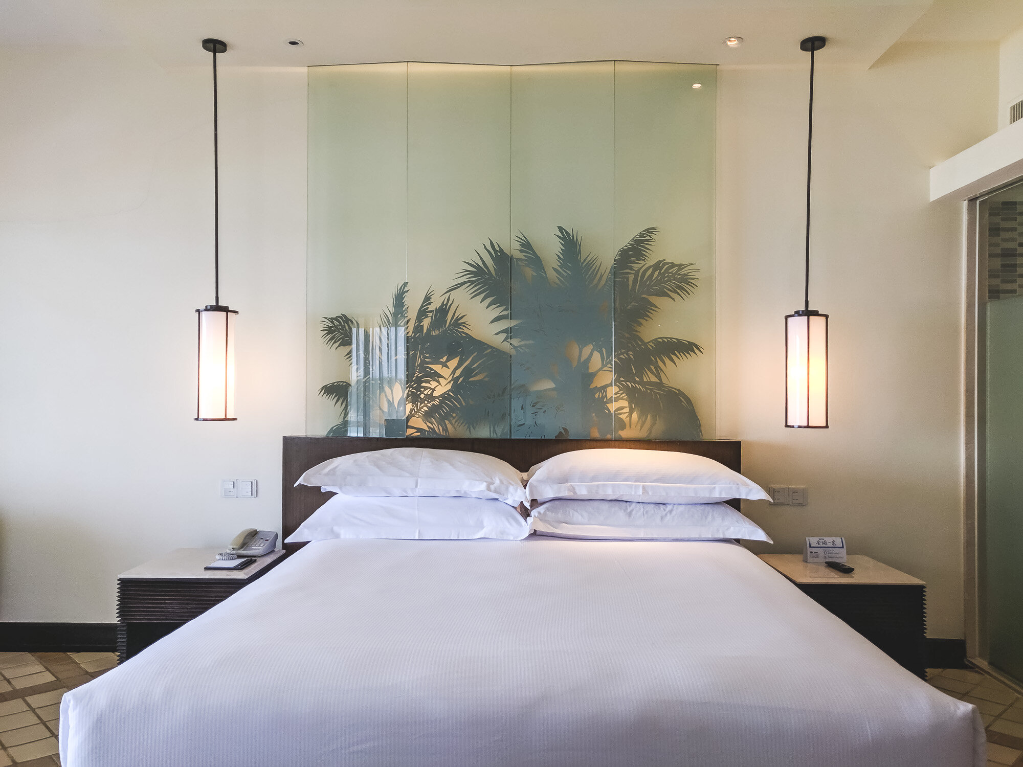 Nice silhouette of palm trees behind the bed
